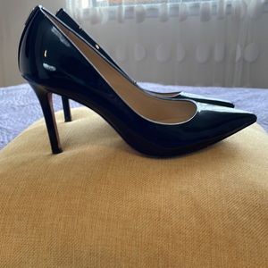 Coach parent leather pumps.